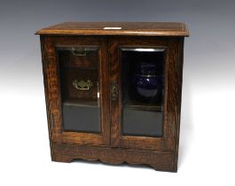 Early 20th century oak smokers cabinet with pottery tobacco jar, 34 x 34cm.