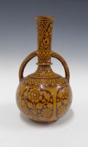 Eastern slip glazed terracotta vessel with loop handles and floral pattern, 18 x 31cm.