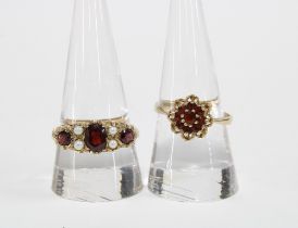 9ct gold garnet flowerhead ring and a garnet and pearl ring, set in yellow metal (2)