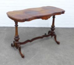 Victorian mahogany table, shaped top on carved end supports with wavy stretcher, 167 x 69 x 53cm.