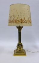 Brass Corinthian column table lamp with lion mask heads, complete with shade