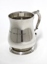 Tiffany & Co, Sterling silver Christening beaker of plain baluster form with a leaf capped handle,