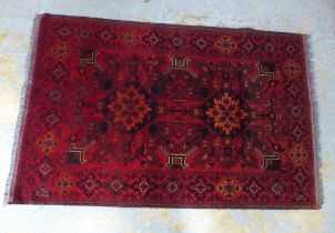 Persian / Afghan rug with red field, 208 x 130cm.