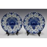 Two Delft blue and white chargers, with basket of flowers pattern (2) 29cm.