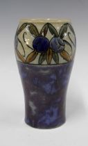 Royal Doulton vase by Bessie Newberry, blue ground with a band of fruit and foliage, impressed marks