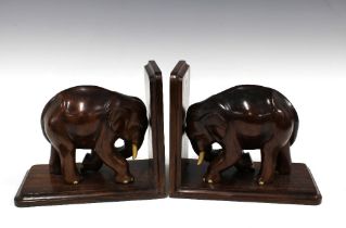 A pair of Elephant wooden bookends with faux ivory tusks (2) 20 x 17cm.