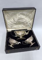 Indian three piece white metal teaset, unmarked, with repousee pattern of a village setting with