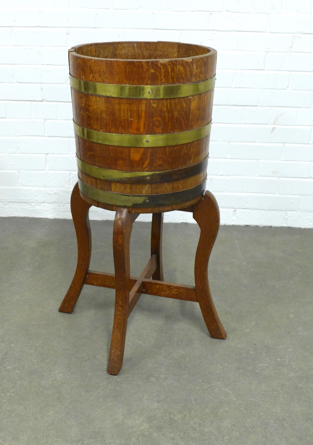 An oak and brass mounted barrel on stand, 40 x 86cm.
