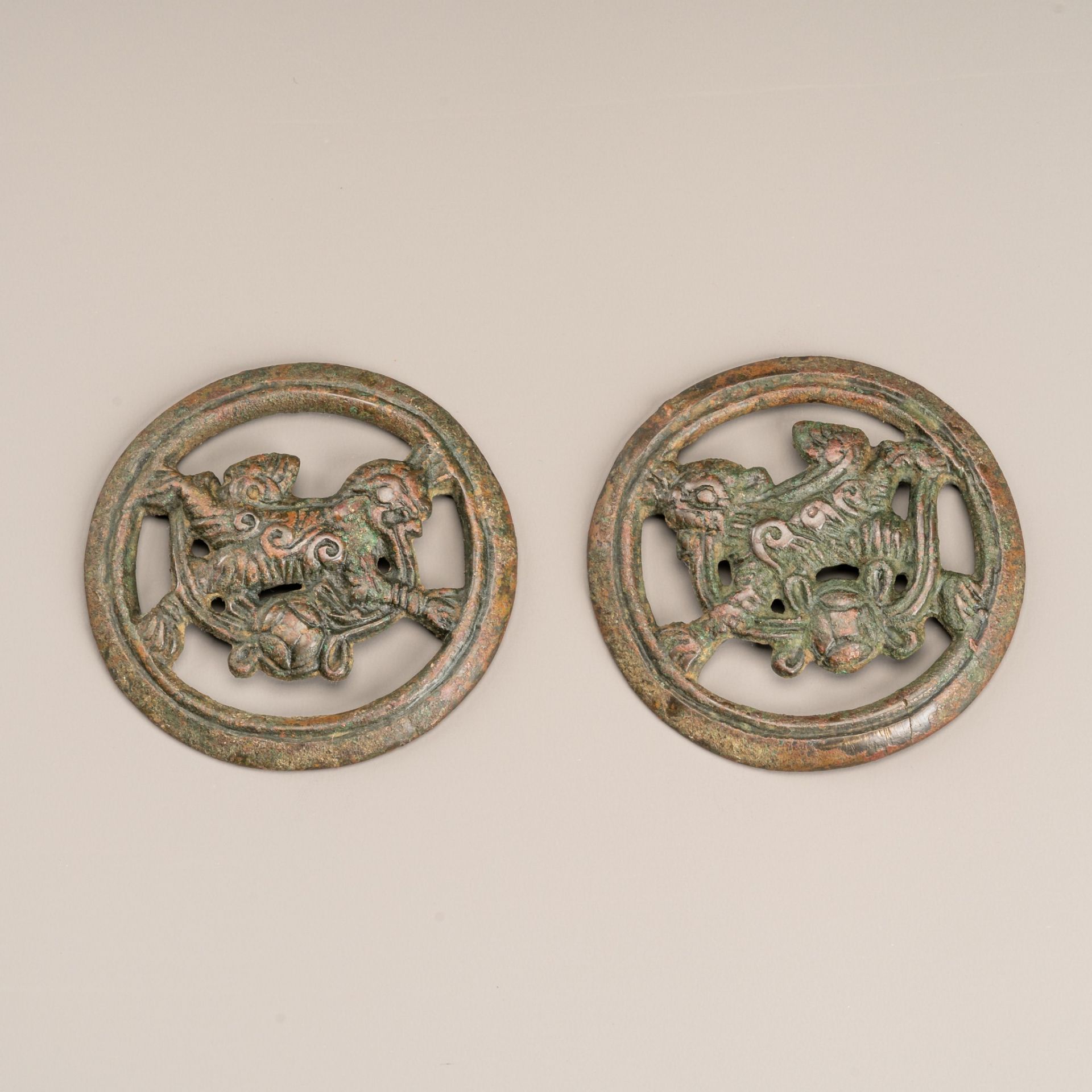 A PAIR OF BRONZE HORSE TRACK 'BUDDHIST LION' ORNAMENTS, MING OR EARLIER