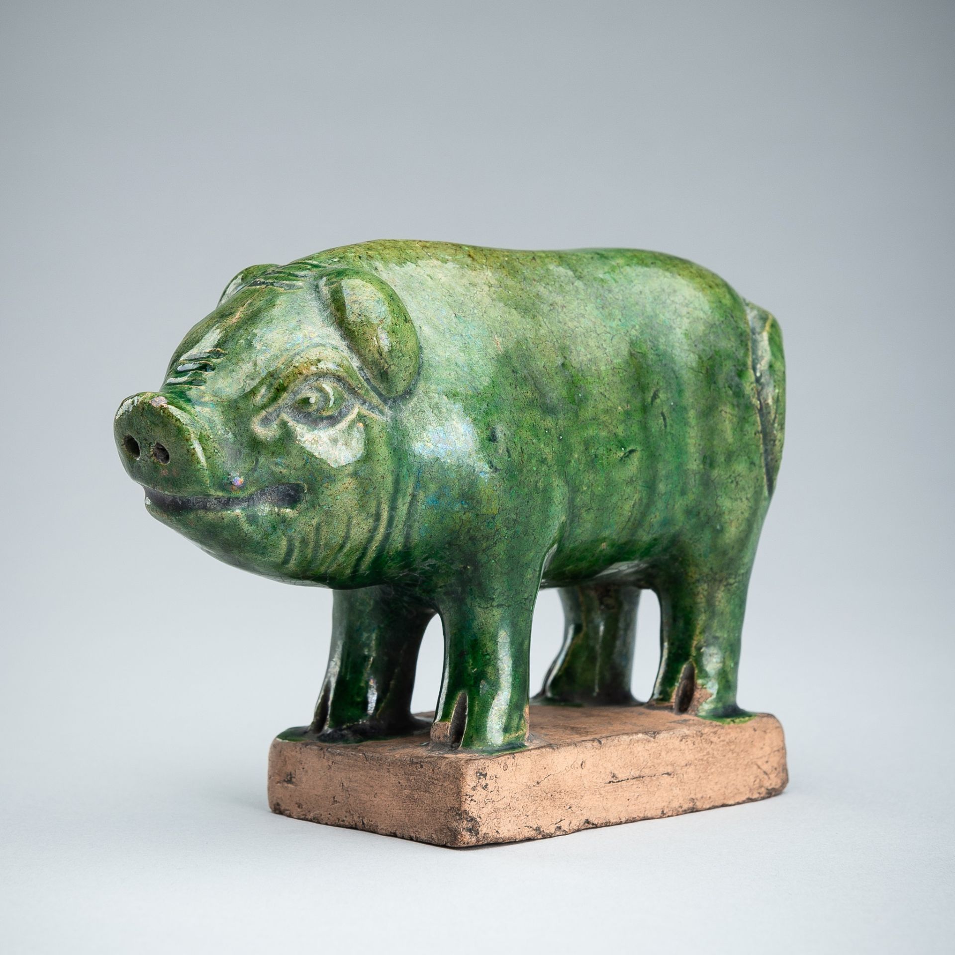 AN EMERALD-GREEN GLAZED POTTERY PIG, MING DYNASTY
