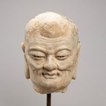 A STUCCO HEAD OF A LUOHAN, YUAN TO MING