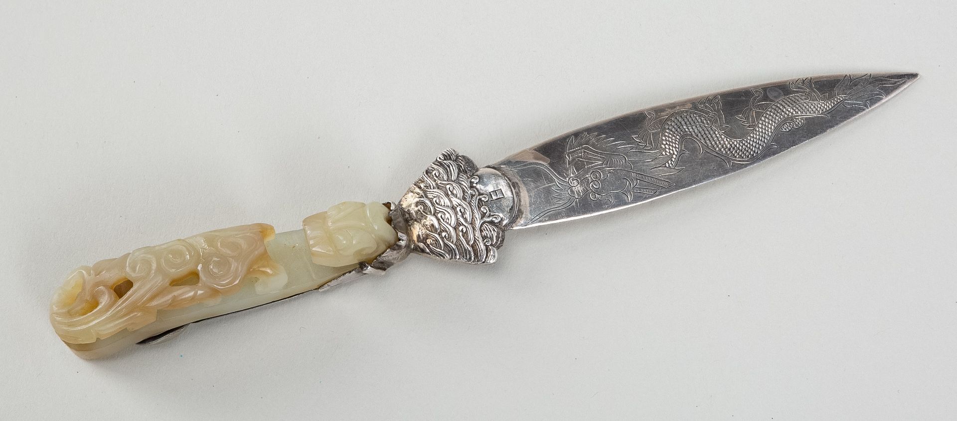 A PALE CELADON JADE 'CHILONG' BELT HOOK MOUNTED IN SILVER AS A LETTER OPENER, 19th CENTURY