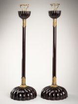 A PAIR OF BLACK LACQUERED CANDLESTICKS