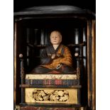 A LACQUERED WOOD ZUSHI (PORTABLE SHRINE) CONTAINING A PAINTED FIGURE OF THE PRIEST KUKAI (KOBO DAISH