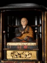 A LACQUERED WOOD ZUSHI (PORTABLE SHRINE) CONTAINING A PAINTED FIGURE OF THE PRIEST KUKAI (KOBO DAISH