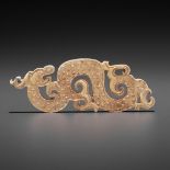 A SMALL JADE PENDANT DEPICTING A COILED DRAGON, EASTERN ZHOU