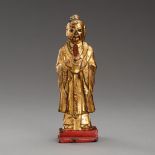 A GILT-LACQUERED BRONZE FIGURE OF AN OFFICIAL, QING OR EARLIER