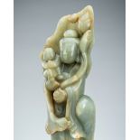 A CELADON BOWENITE FIGURE OF GUANYIN WITH CHILD