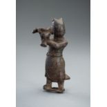 A BRONZE 'BOY' JOSS STICK HOLDER, MING DYNASTY