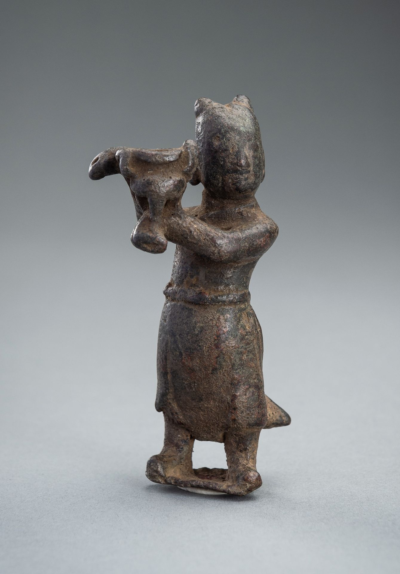 A BRONZE 'BOY' JOSS STICK HOLDER, MING DYNASTY