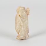A JADE FIGURE OF A BOY HOLDING A LOTUS SPRAY, MING DYNASTY OR EARLIER