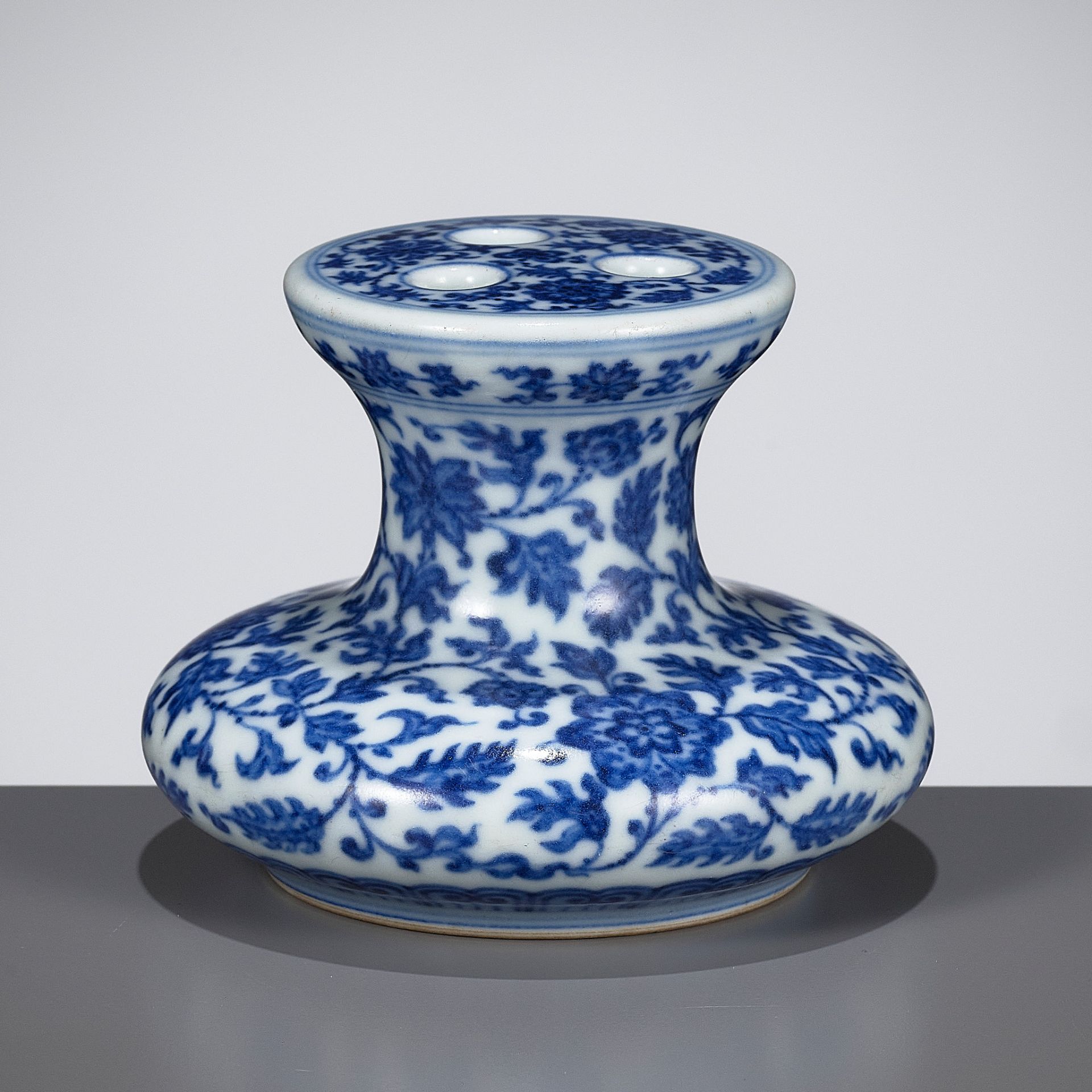 A BLUE AND WHITE MING-STYLE FLOWER-HOLDER, QIANLONG MARK AND PERIOD
