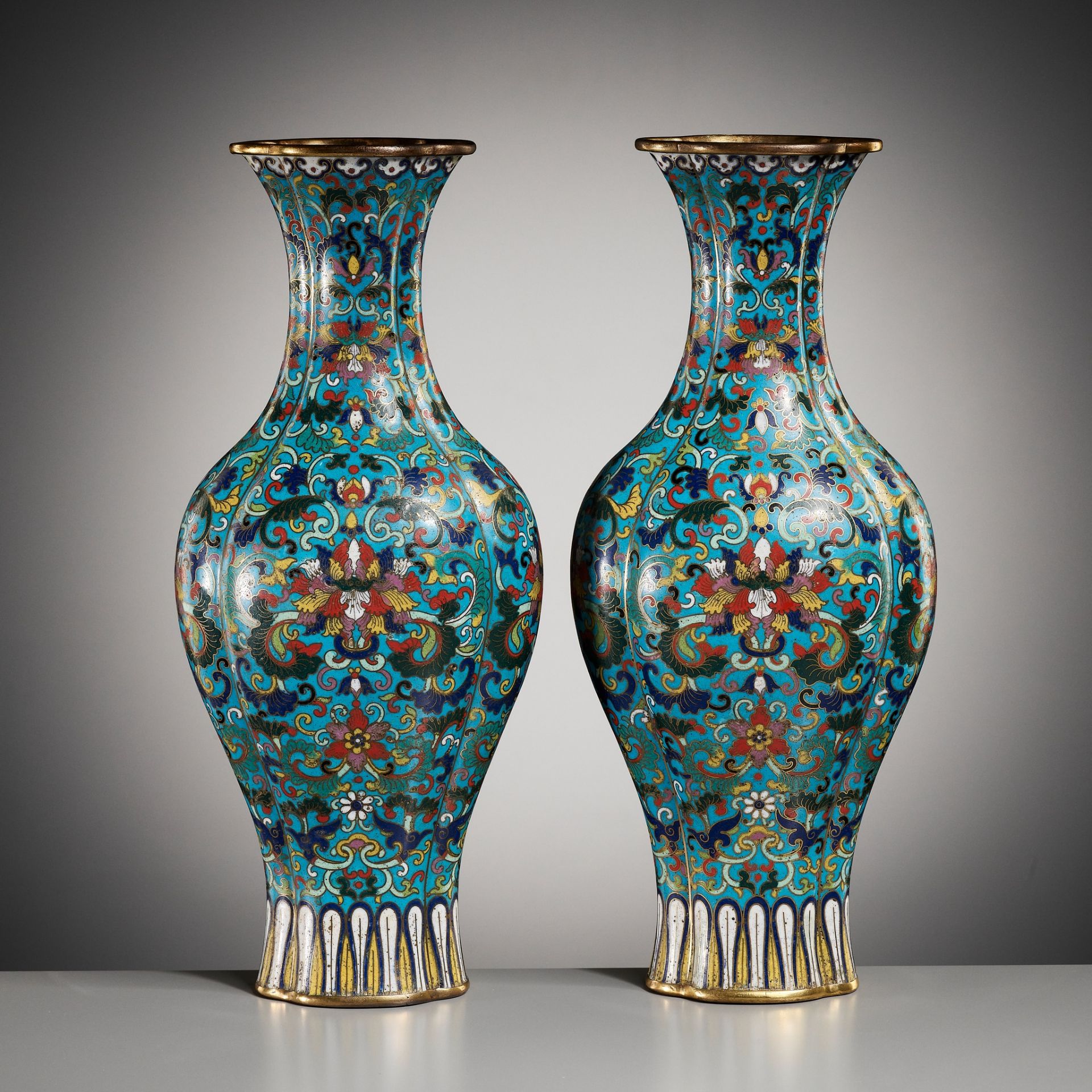 AN IMPERIAL PAIR OF QUADRILOBED CLOISONNÉ ENAMEL ‘LOTUS’ VASES, QIANLONG MARK AND OF THE PERIOD