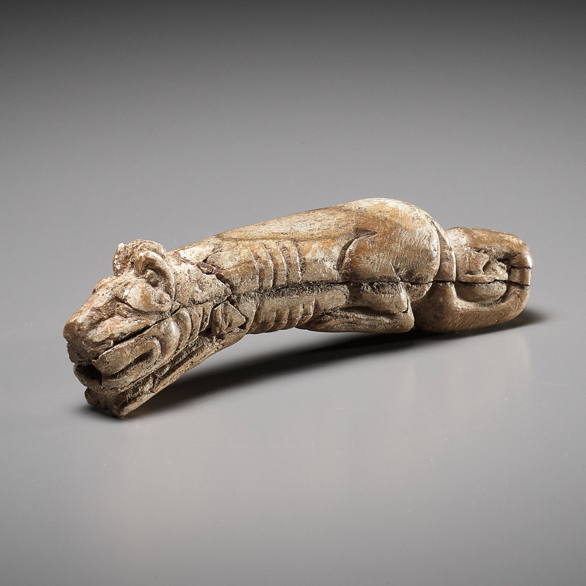 A RARE CARVED BONE FIGURE OF A TIGER, SHANG DYNASTY