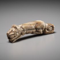 A RARE CARVED BONE FIGURE OF A TIGER, SHANG DYNASTY