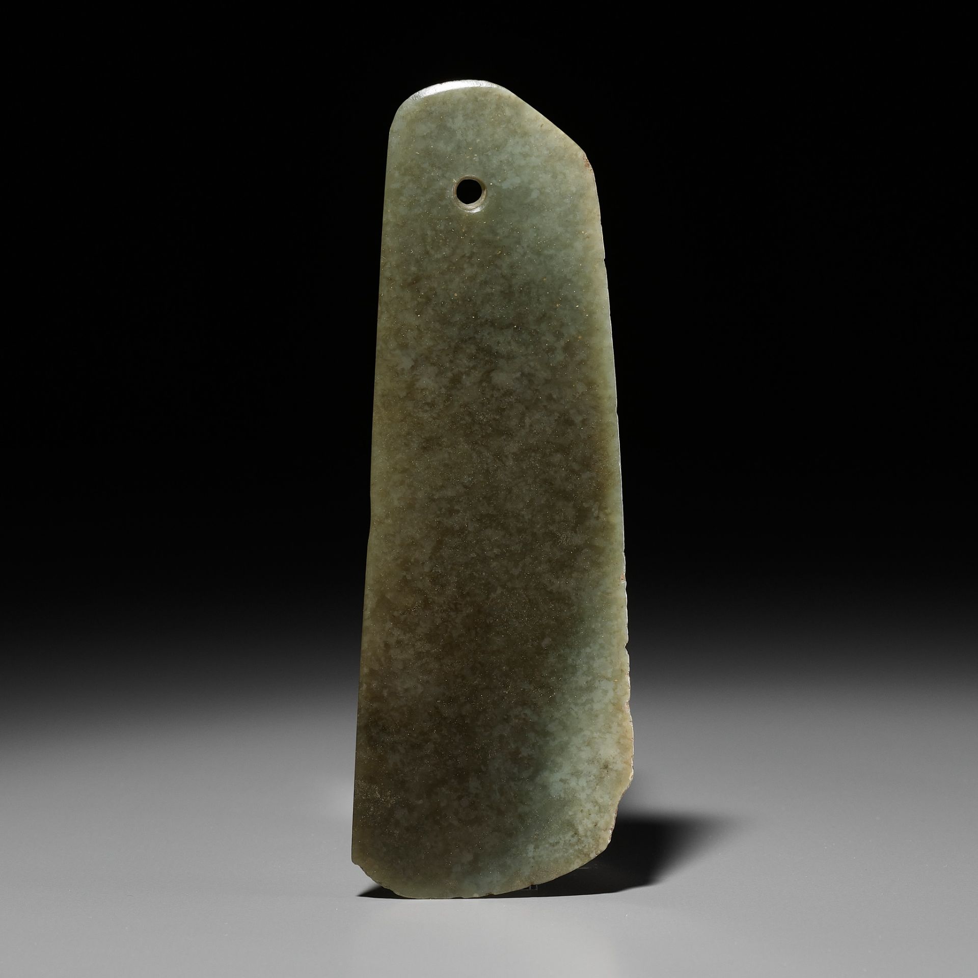 AN ARCHAIC CEREMONIAL JADE BLADE, YUE, NEOLITHIC PERIOD TO SHANG DYNASTY