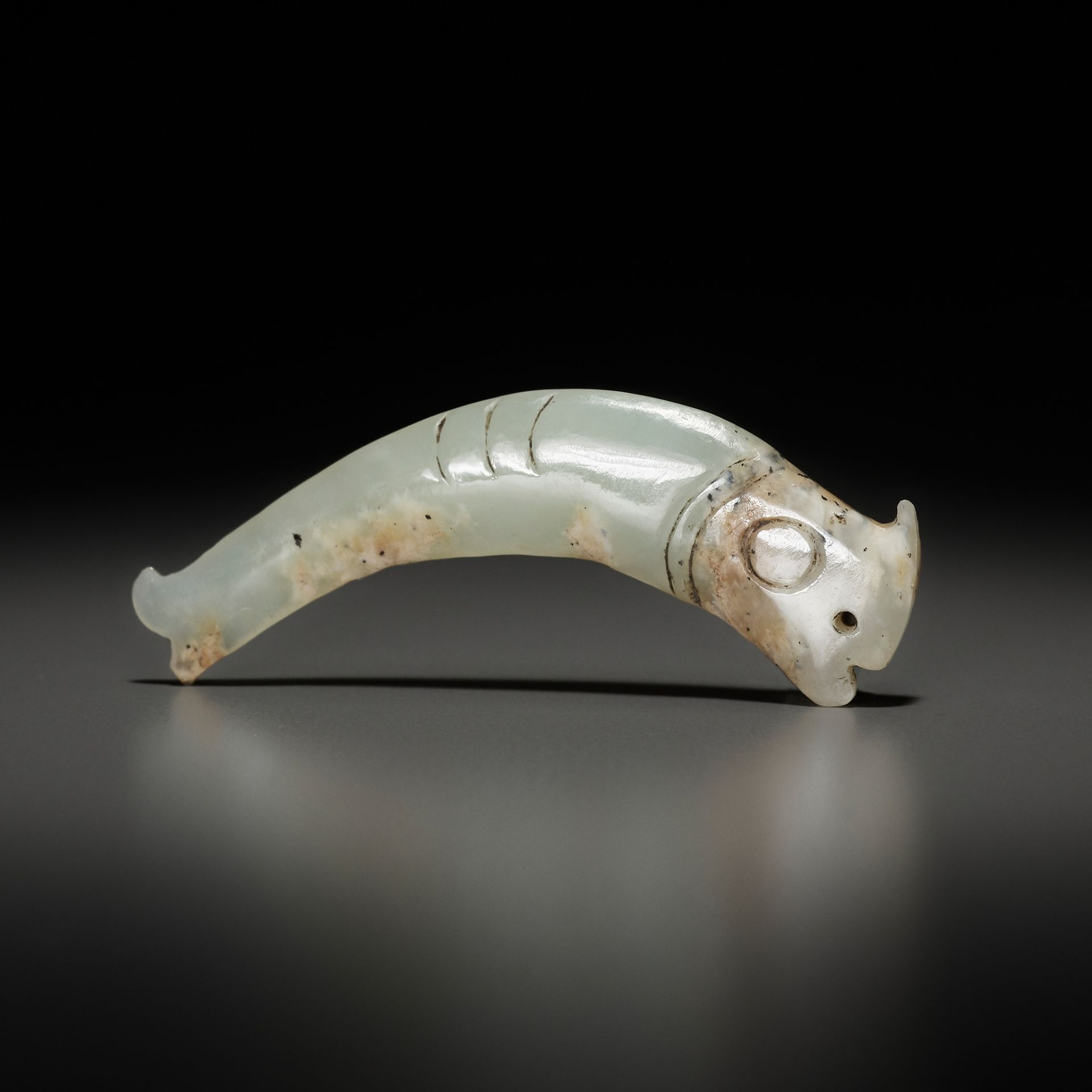 A PALE CELADON 'FISH' PENDANT, LATE SHANG TO EARLY WESTERN ZHOU DYNASTY