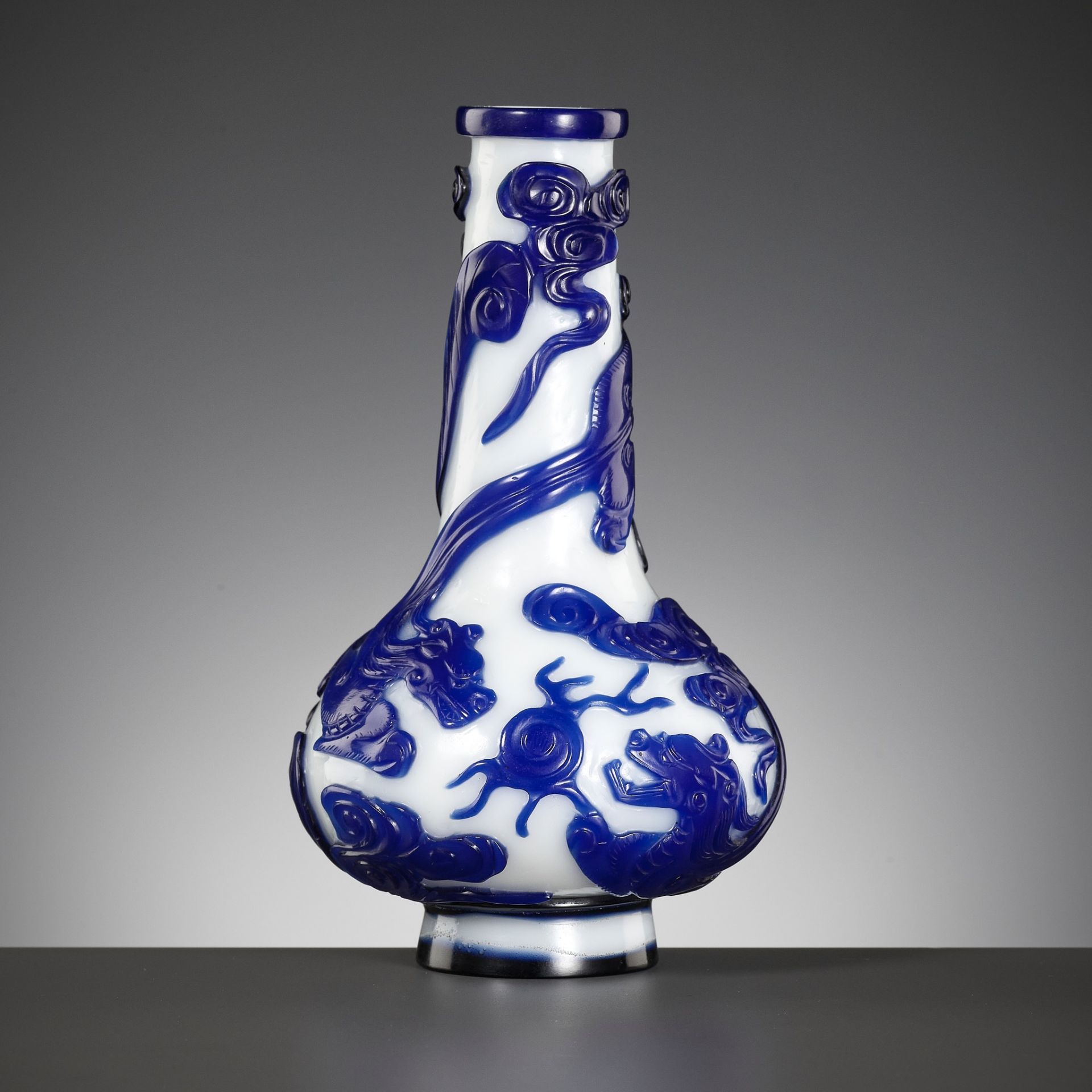 A SAPPHIRE-BLUE OVERLAY GLASS 'CHILONG' BOTTLE VASE, QIANLONG MARK AND POSSIBLY OF THE PERIOD