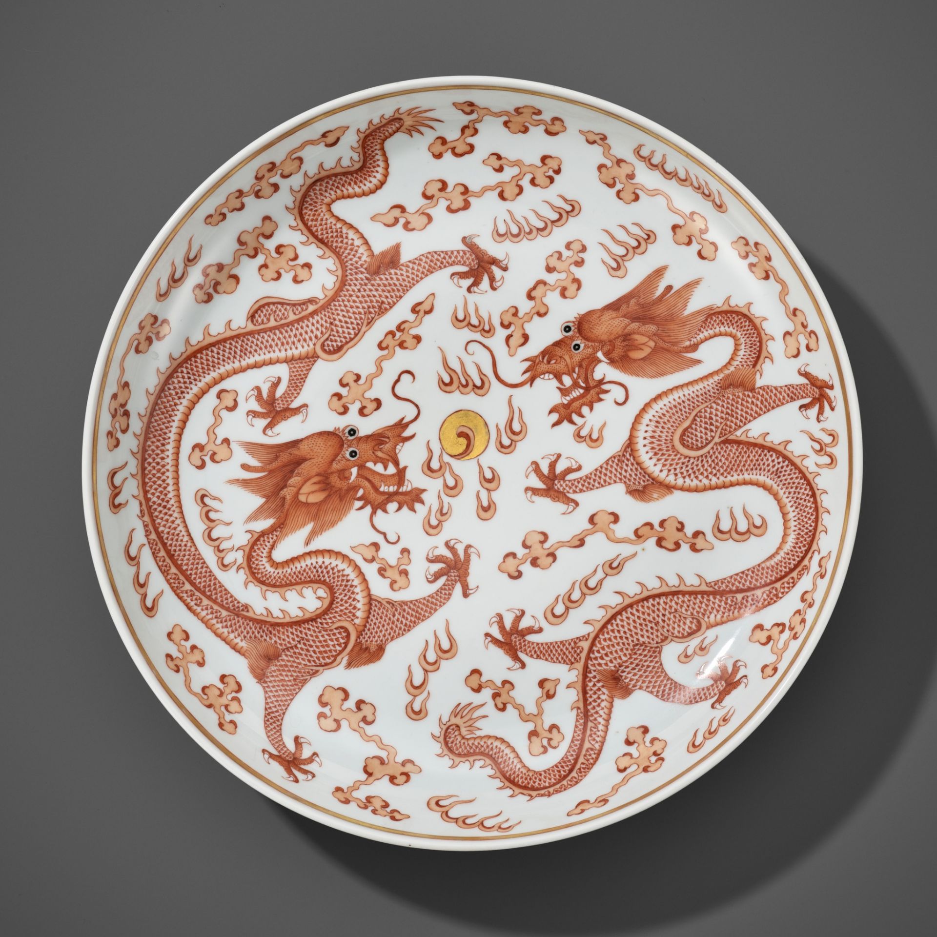 A LARGE IRON-RED AND GILT 'DRAGONS' DISH, GUANGXU MARK AND PERIOD