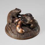 KEIGETSU: A WOOD NETSUKE OF RATS ON A STRAW HAT