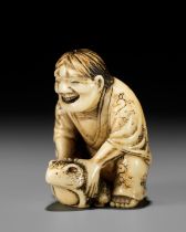 MASATSUGU: AN AMUSING OSAKA SCHOOL IVORY NETSUKE OF GAMA SENNIN LIFTING HIS TOAD