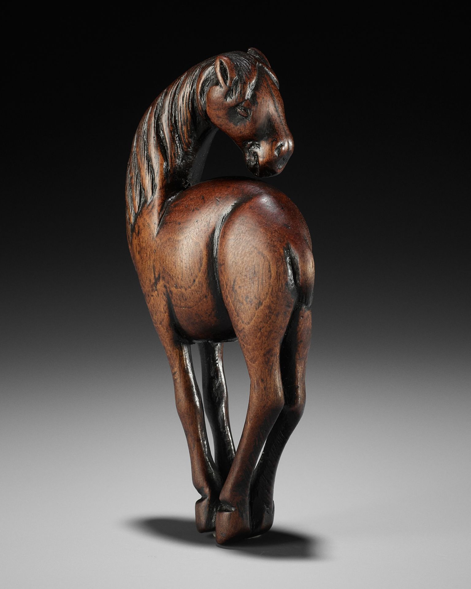 A SUPERB AND LARGE WOOD NETSUKE OF A HORSE