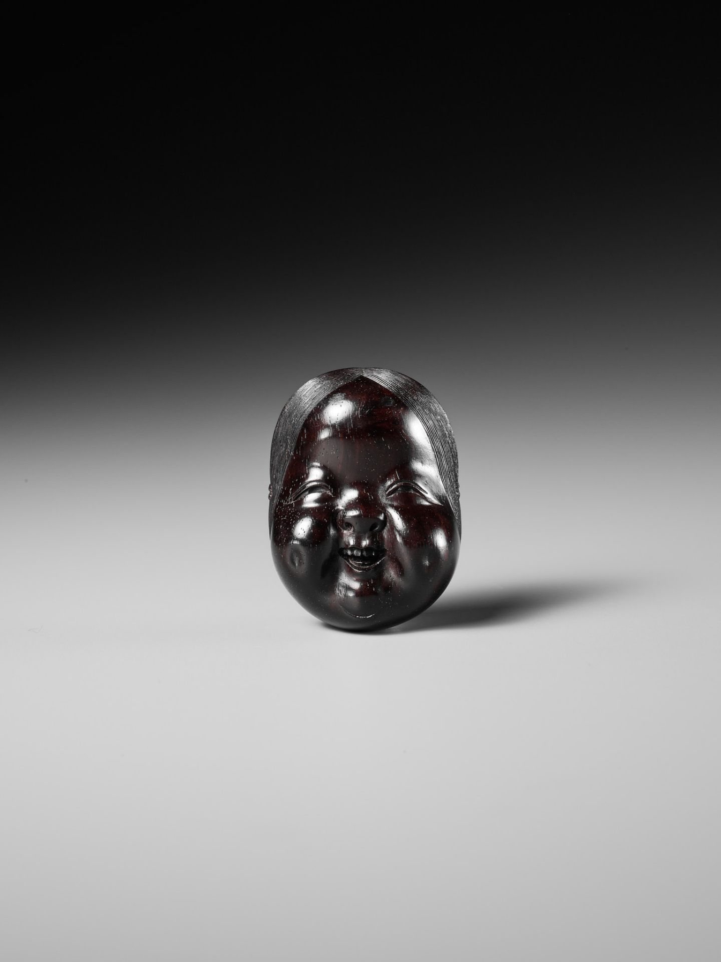 MEIKEISAI HOJITSU: A FINE DARK WOOD MASK NETSUKE OF OKAME - Image 3 of 13