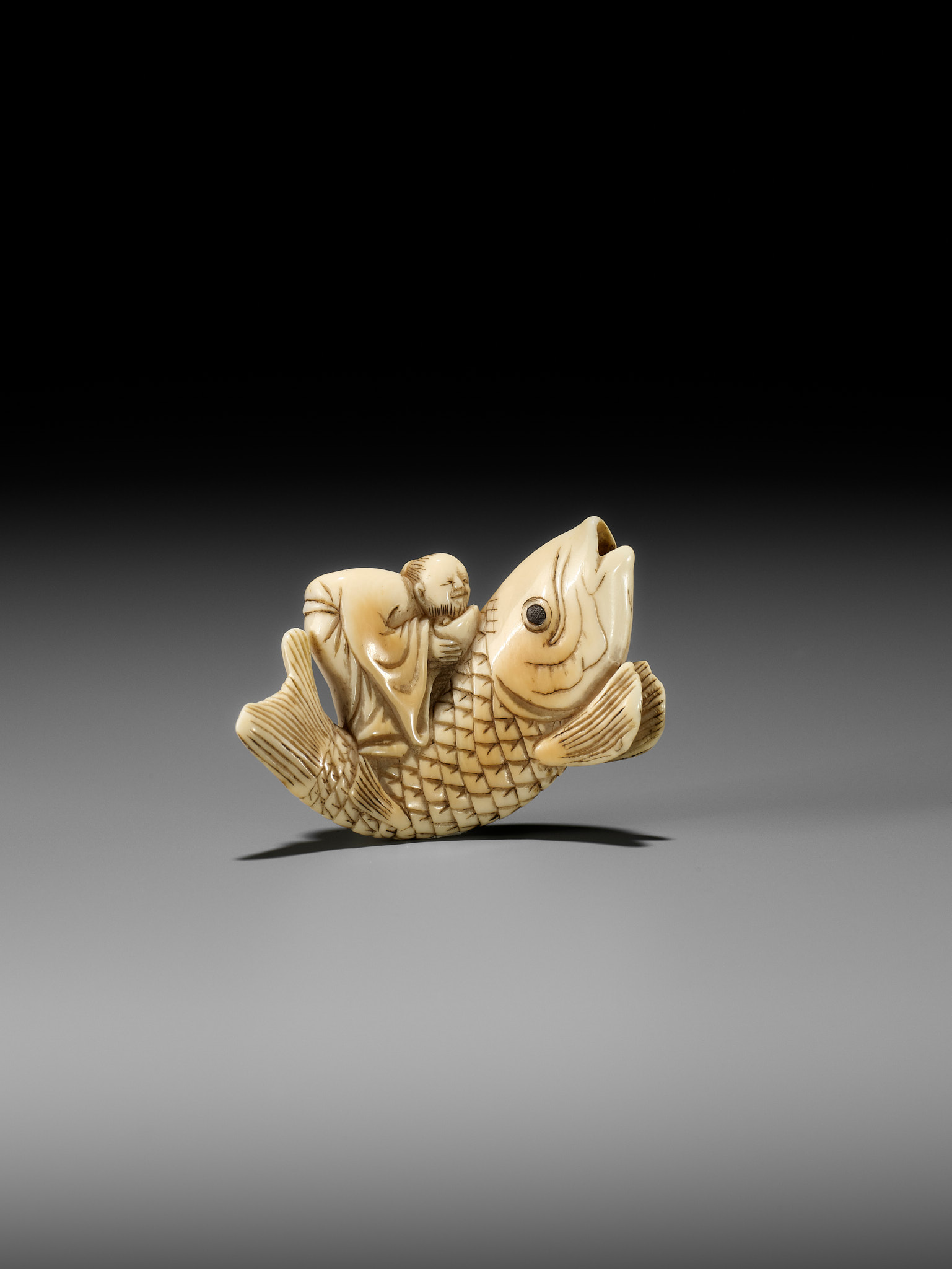 YOSHITSUGU: AN EARLY IVORY NETSUKE OF KINKO SENNIN ON A CARP - Image 2 of 14