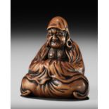 MINKOKU: A SUPERB WOOD NETSUKE OF DARUMA