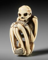 A FINE IVORY NETSUKE OF A SKELETON