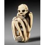 A FINE IVORY NETSUKE OF A SKELETON