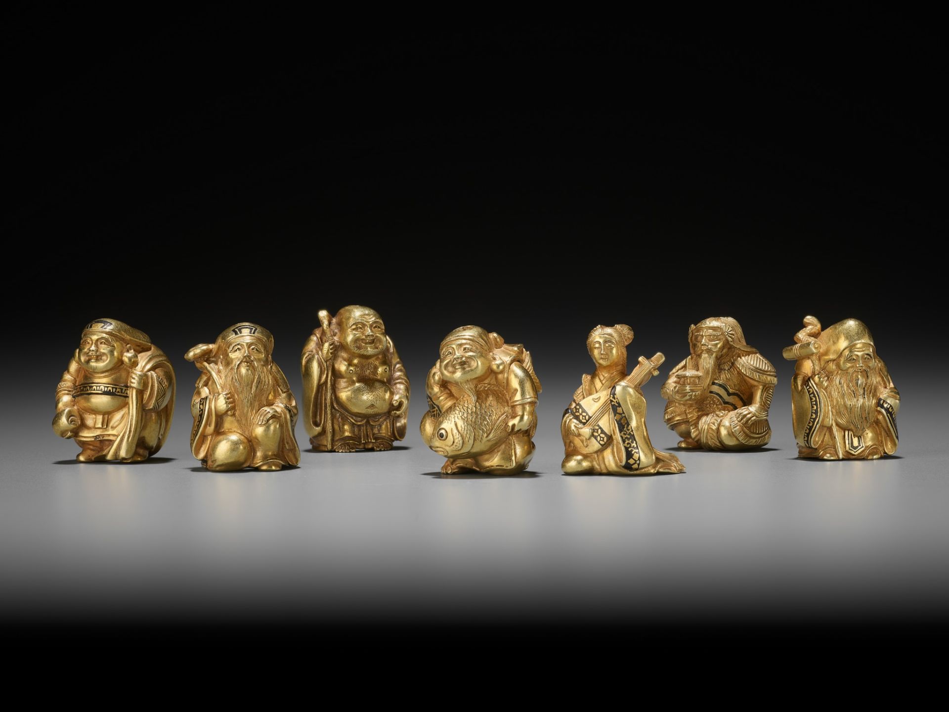 TAKACHIKA: A VERY RARE SOLID GOLD OJIME SET OF THE SEVEN LUCKY GODS (SHICHIFUKUJIN)