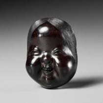 MEIKEISAI HOJITSU: A FINE DARK WOOD MASK NETSUKE OF OKAME