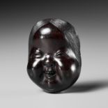 MEIKEISAI HOJITSU: A FINE DARK WOOD MASK NETSUKE OF OKAME