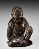 A FINE NETSUKE OF A SEATED IMMORTAL, ATTRIBUTED TO MIWA