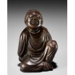 A FINE NETSUKE OF A SEATED IMMORTAL, ATTRIBUTED TO MIWA