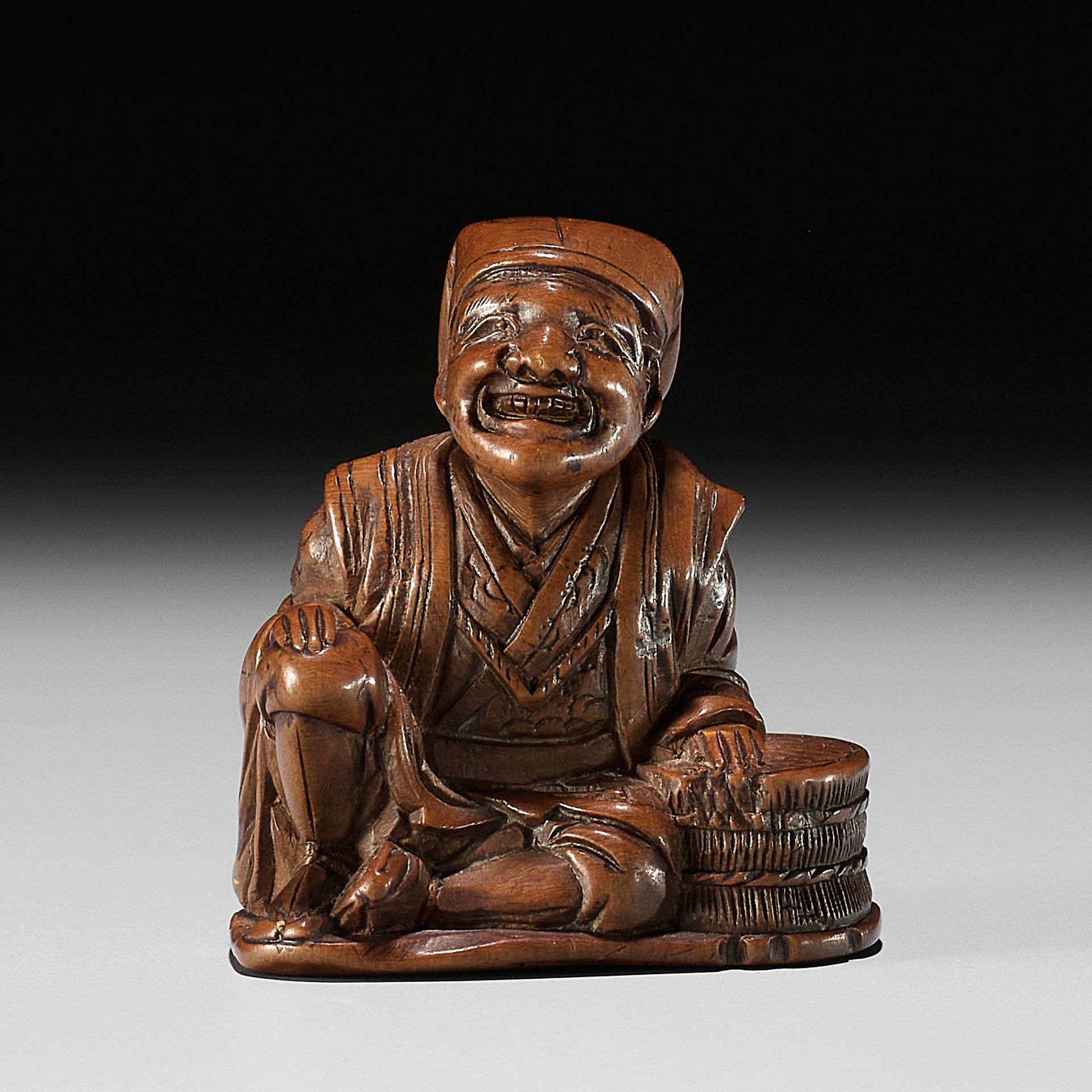 GYOKURINTEI: A WOOD NETSUKE OF A FARMER TAKING A BREAK