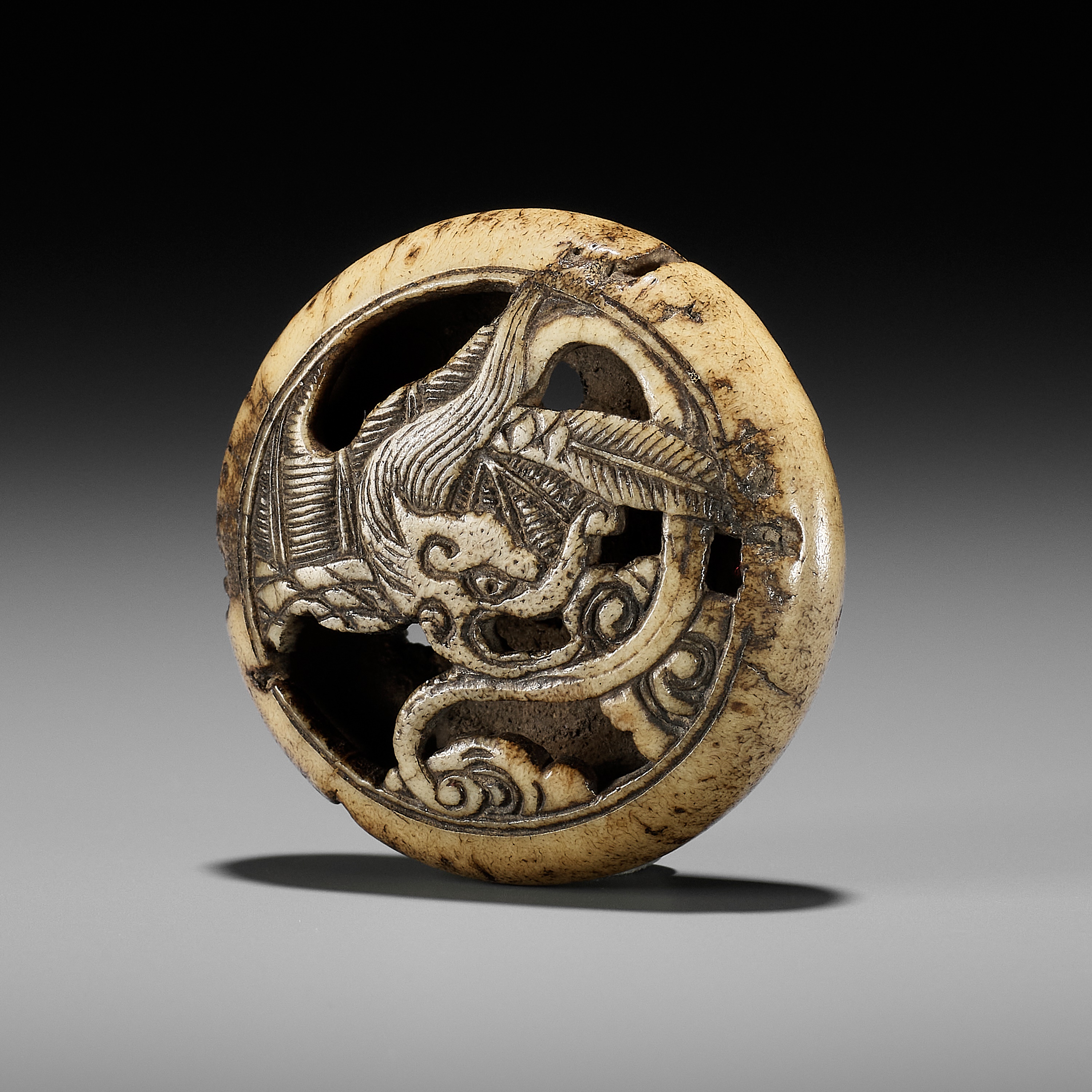 AN ANTLER RYUSA MANJU NETSUKE OF A RAIN DRAGON