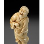 AN EARLY OSAKA SCHOOL IVORY NETSUKE OF A LAUGHING EGG-TESTER