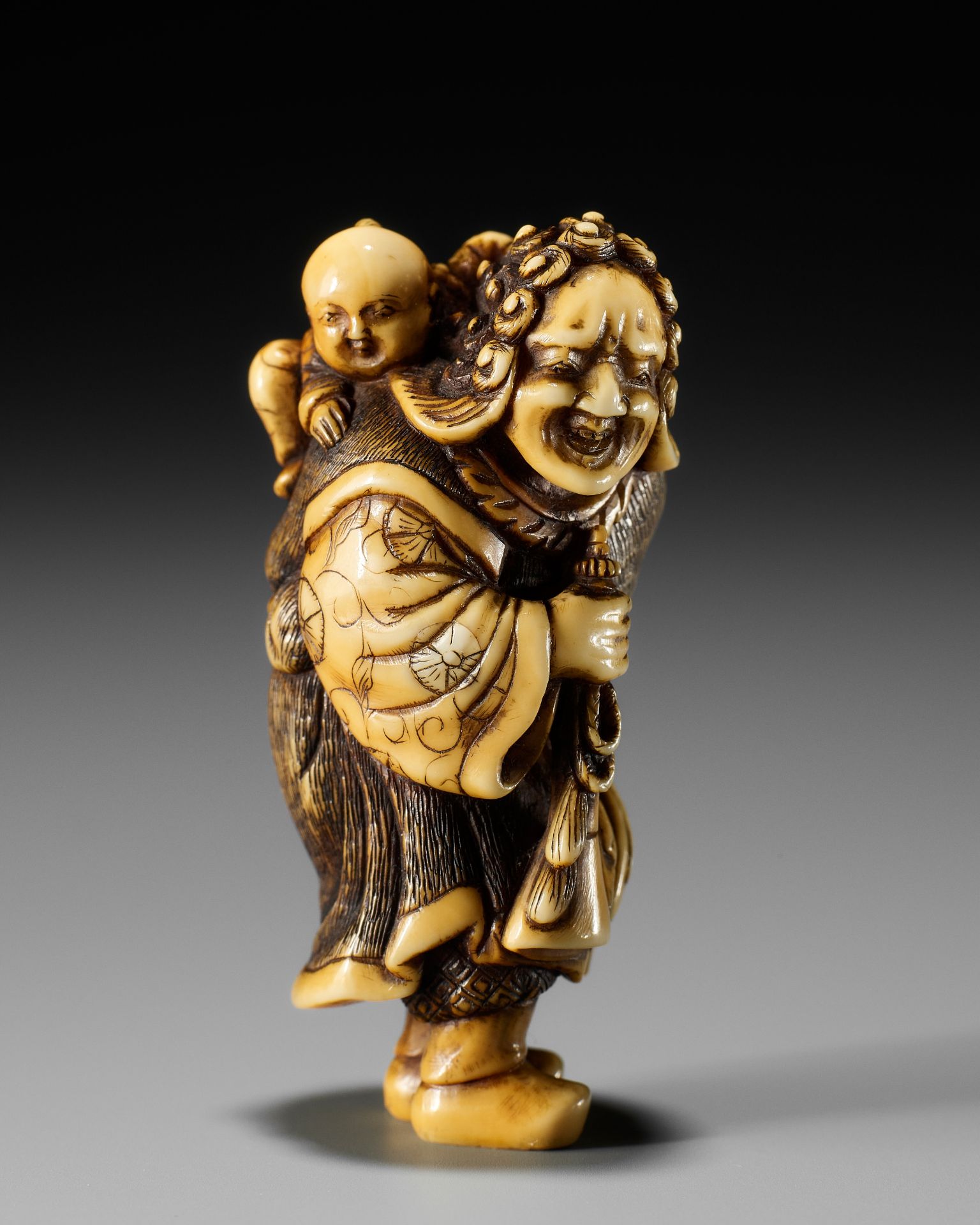 OKAKOTO: A FINE IVORY NETSUKE OF A DUTCHMAN WITH CHILD